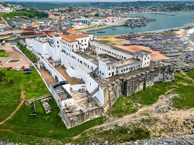 Vue aérienne d'un fort côtier entouré d'une ville et de bateaux.